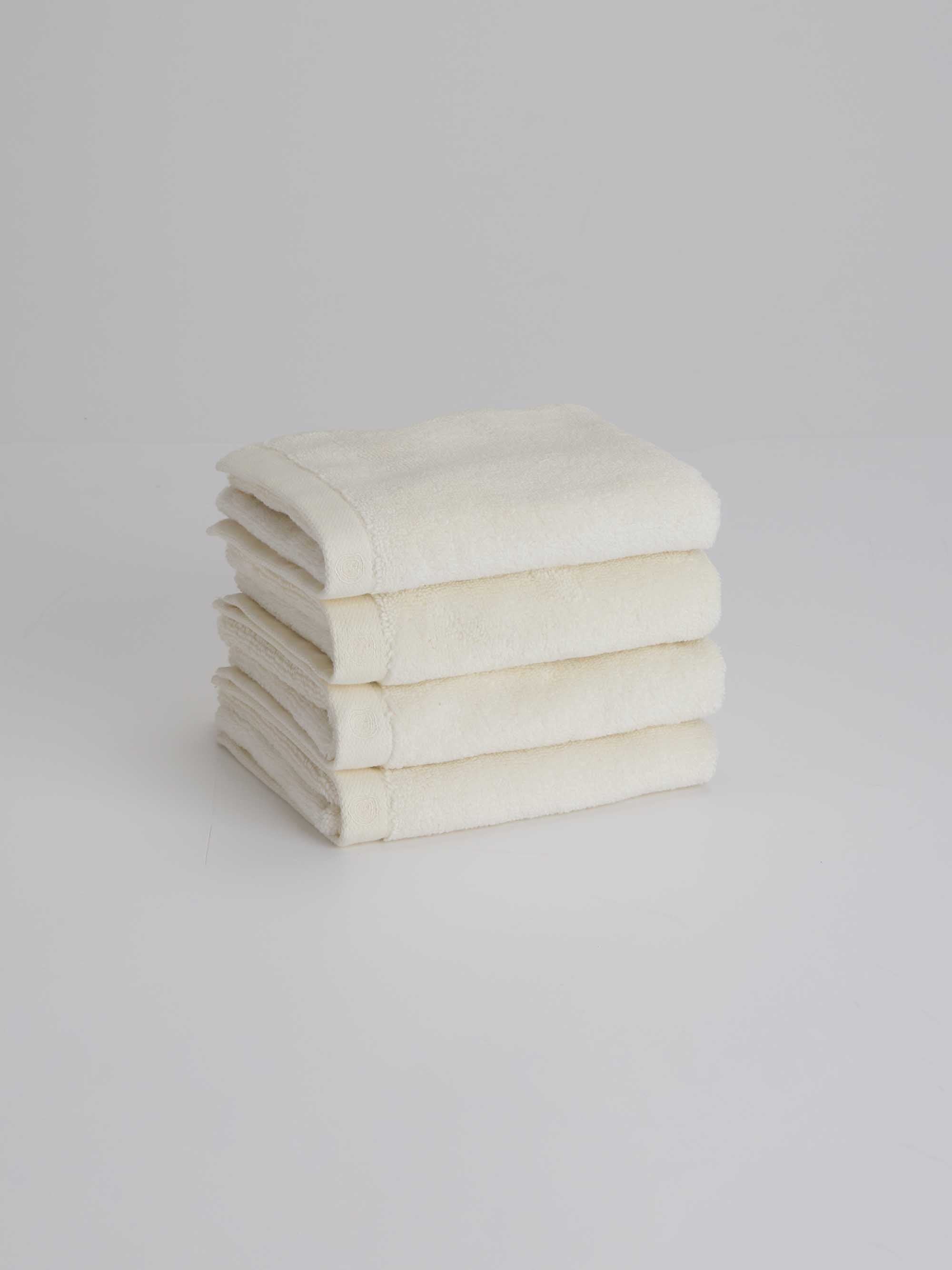 TAKEANAP bamboo zero-twist bath towel in ivory folded on a shelf