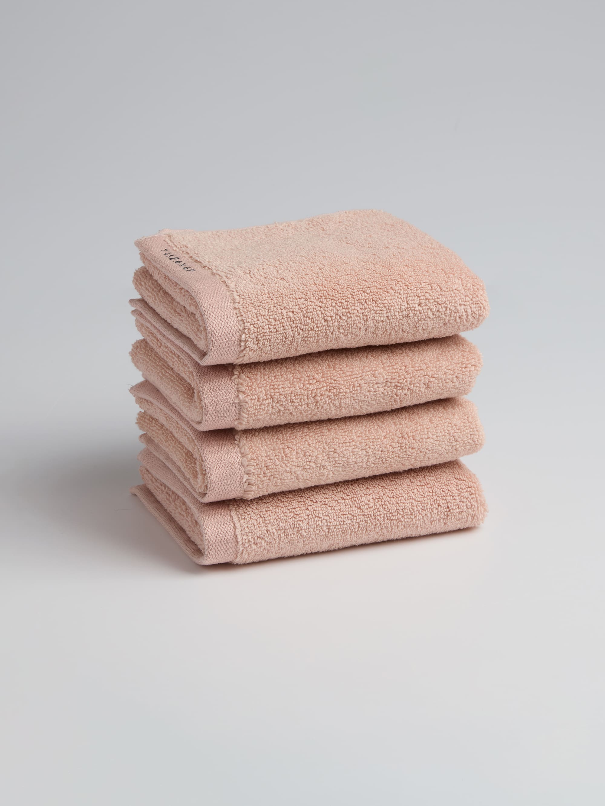 TAKEANAP 700 GSM premium bath towel in pink on a shelf