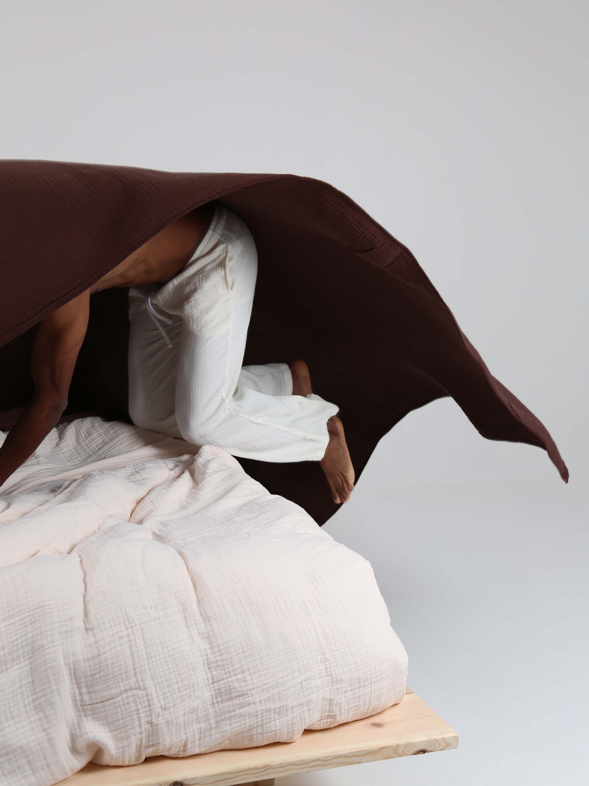 TAKEANAP Dream embroidered muslin coverlet in brownie on a bed