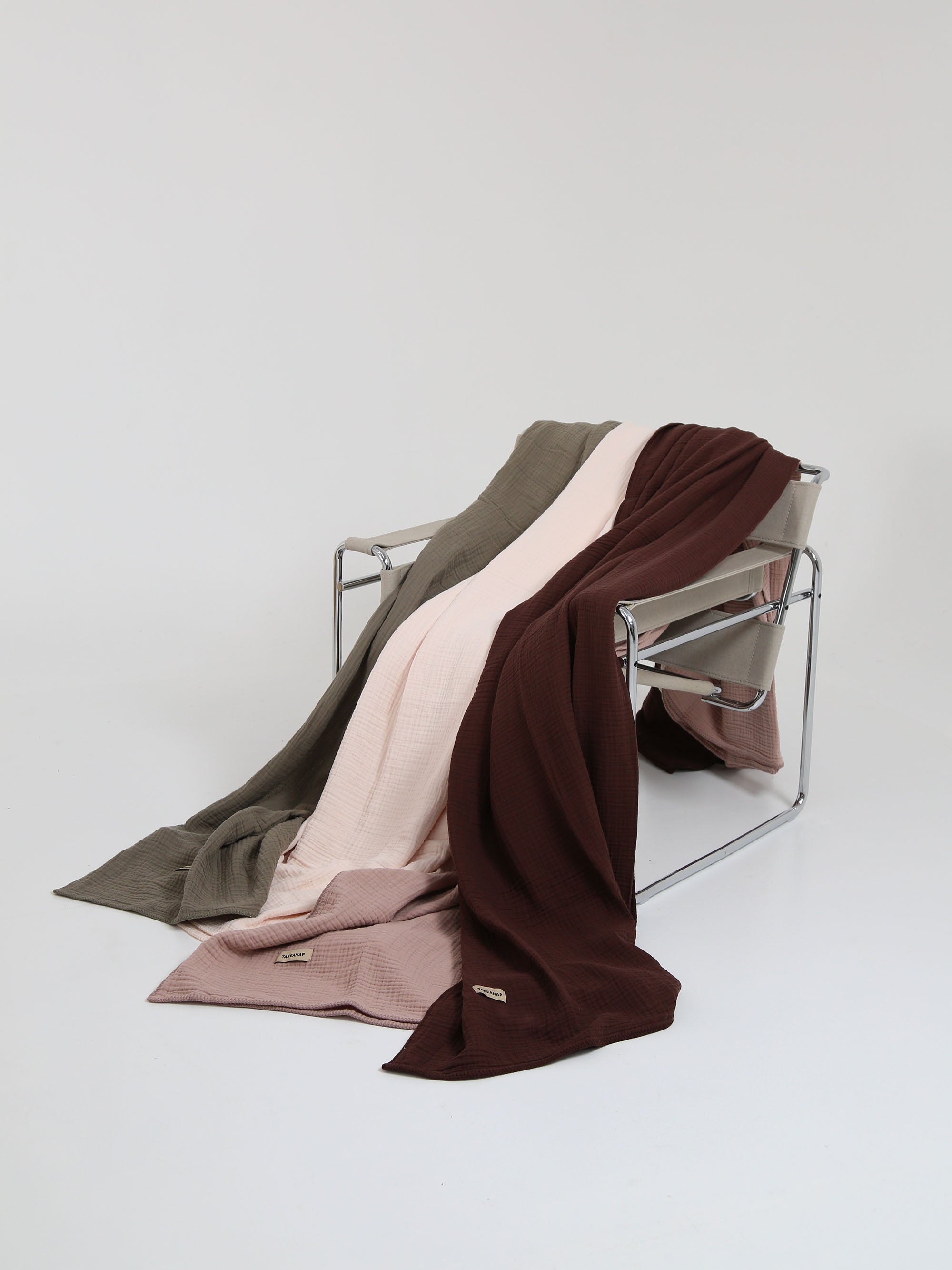 TAKEANAP Dream embroidered muslin coverlet in brownie on a bed