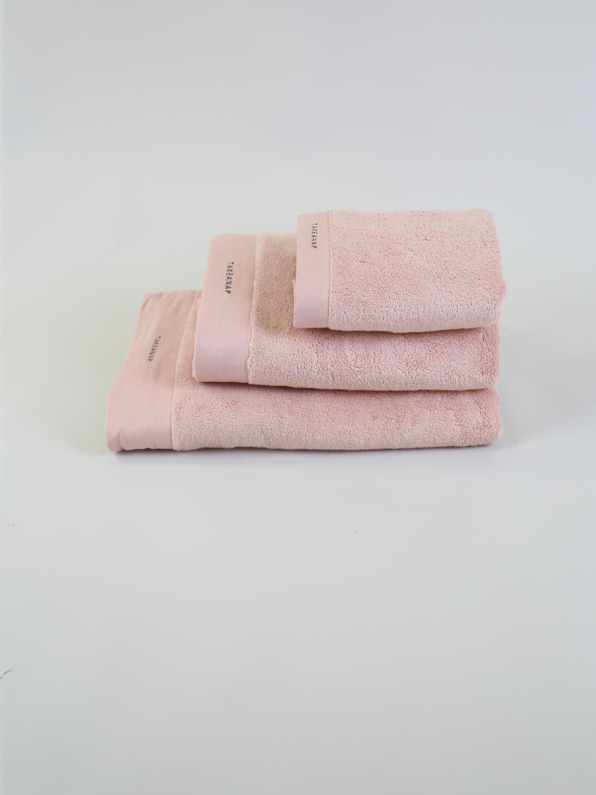 TAKEANAP 700 GSM premium bath towel in pink on a shelf