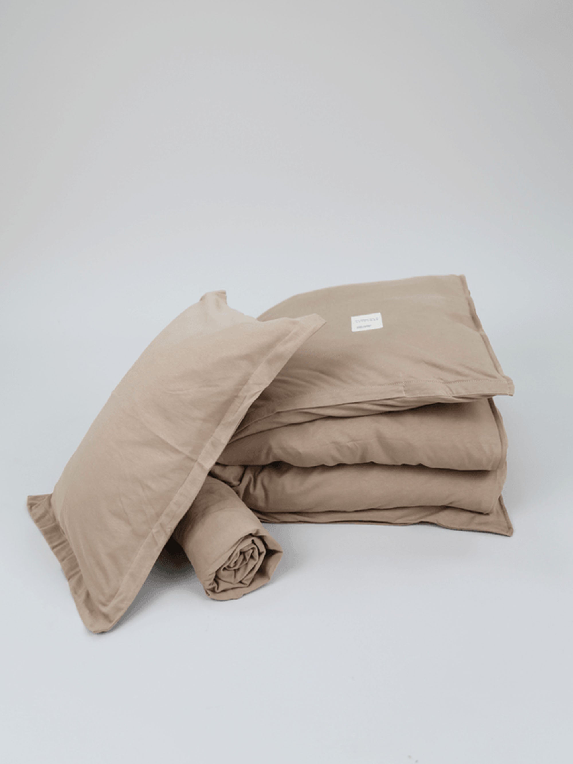 TAKEANAP Oxford jersey toddler bedding set in mocha in a crib