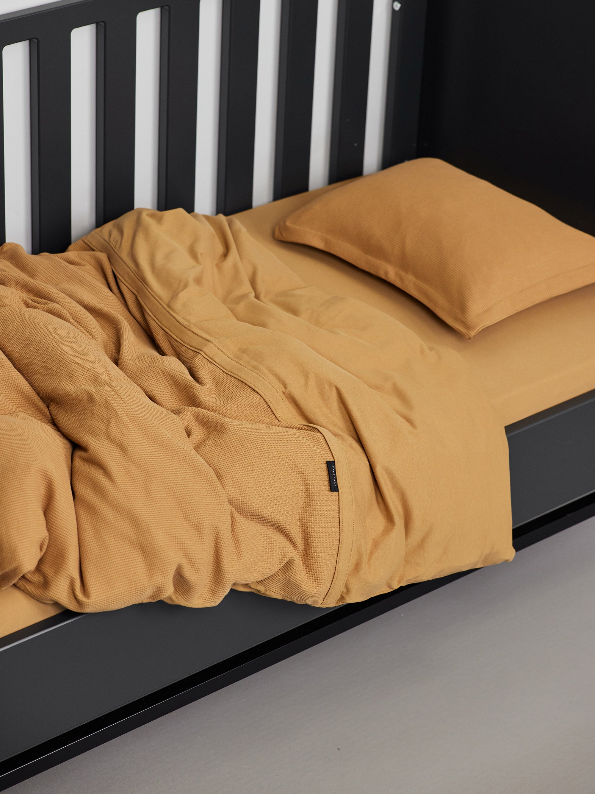 Hey welcome 2 JACQUARD |   Gray Toddler Pillowcase. Image: Duvet, pillow and pillowcase on a black crib with Grey sheet