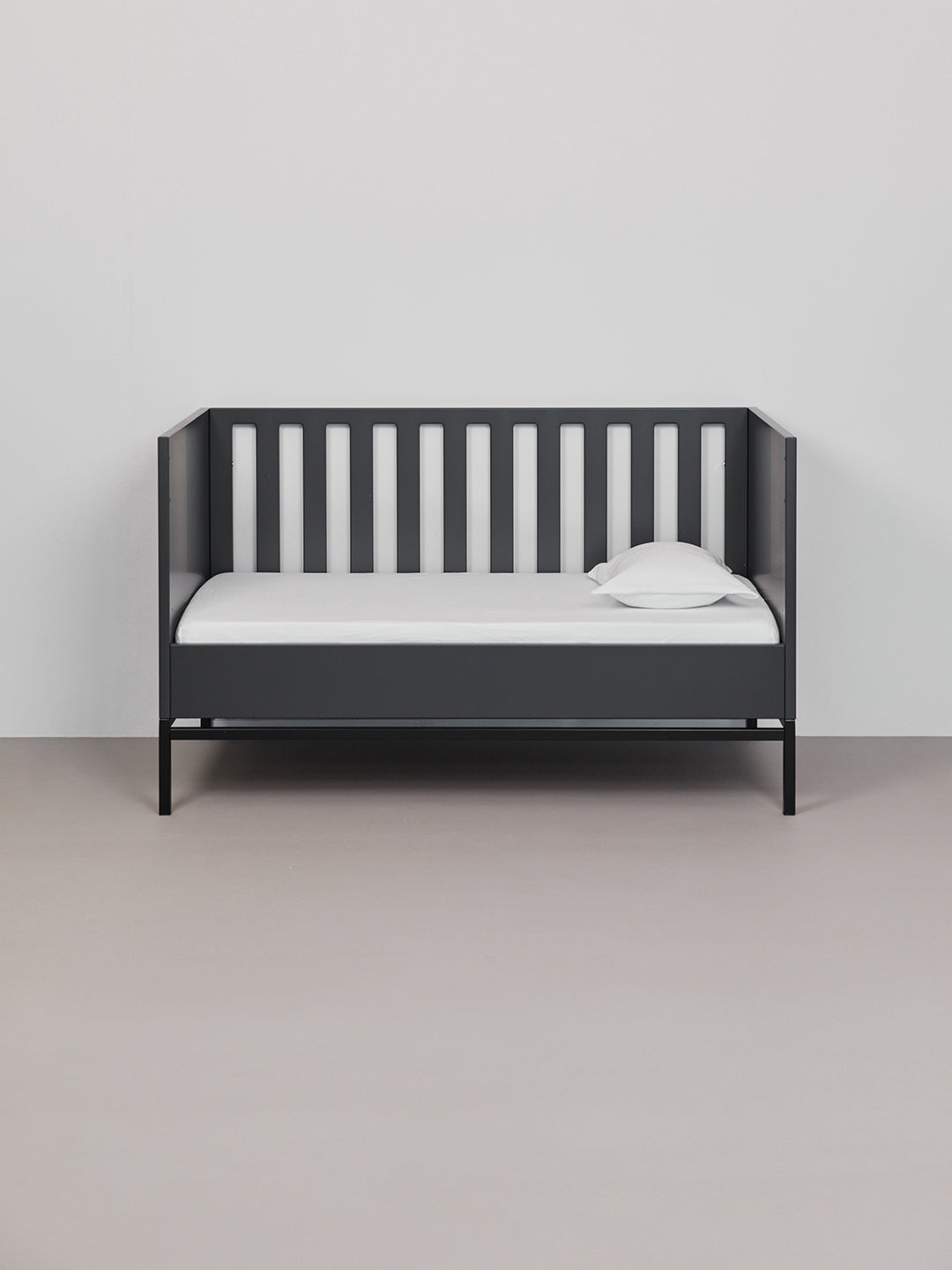 Hey welcome 2 JACQUARD | Tabbaco Toddler Pillowcase. Image: white pillow and pillowcase on a black crib with white sheets
