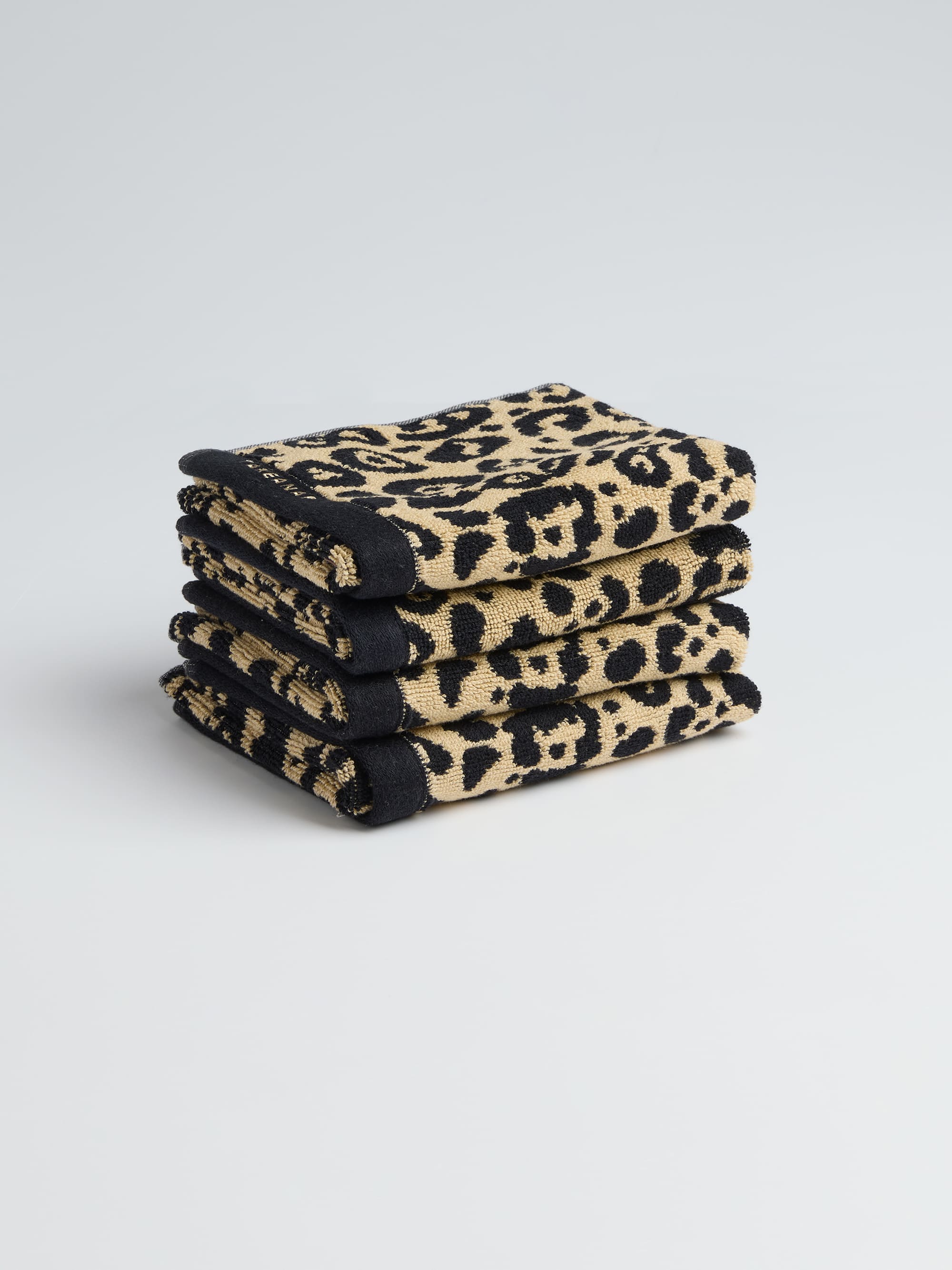 TAKEANAP Leopard terry bath towel folded on a shelf